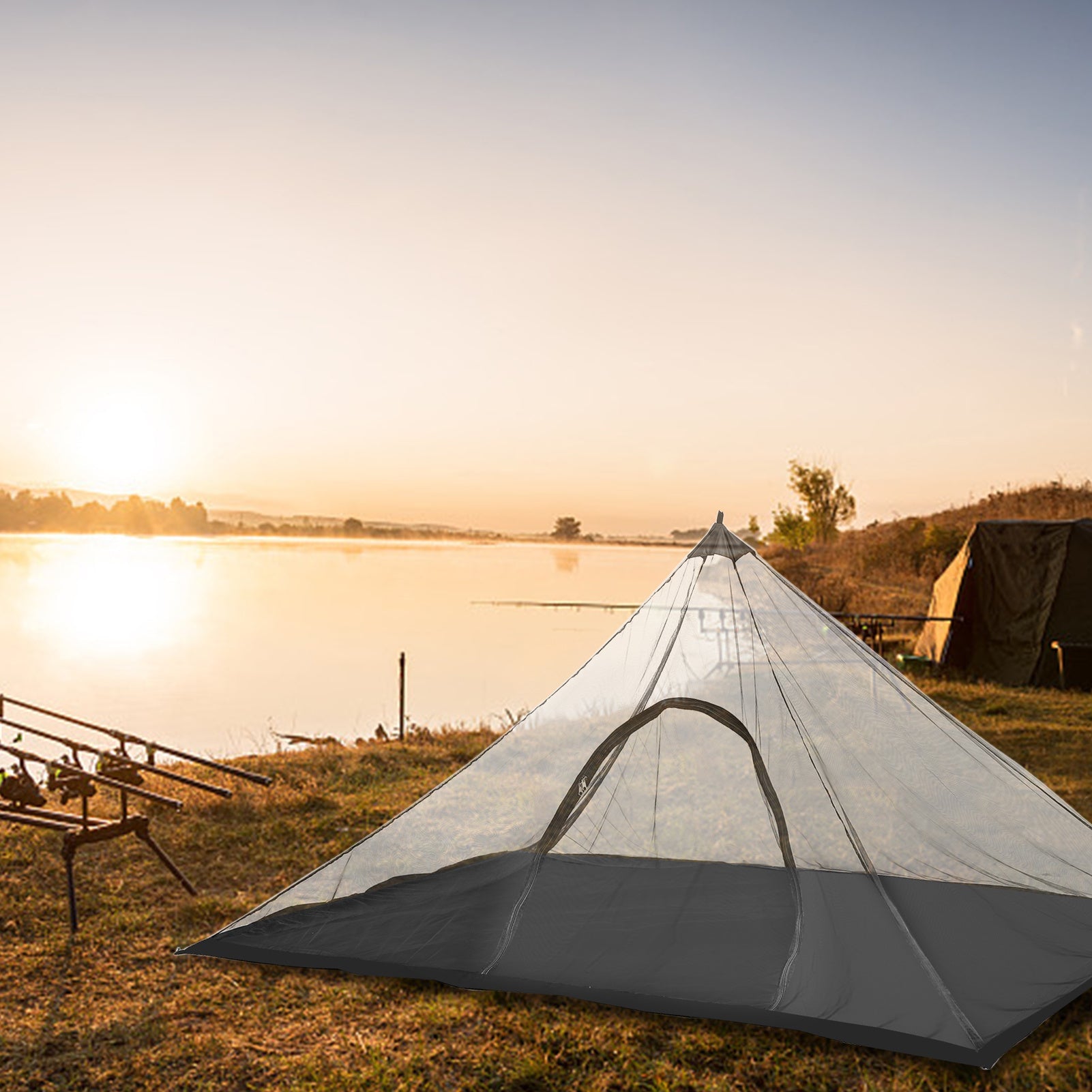 Lightweight mesh camping tent pitched beside a lake at sunset, designed for ventilation and insect protection.